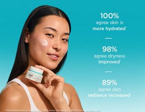 Young woman holding Curél Intensive Moisture Facial Cream with a swatch of moisturiser on cheek